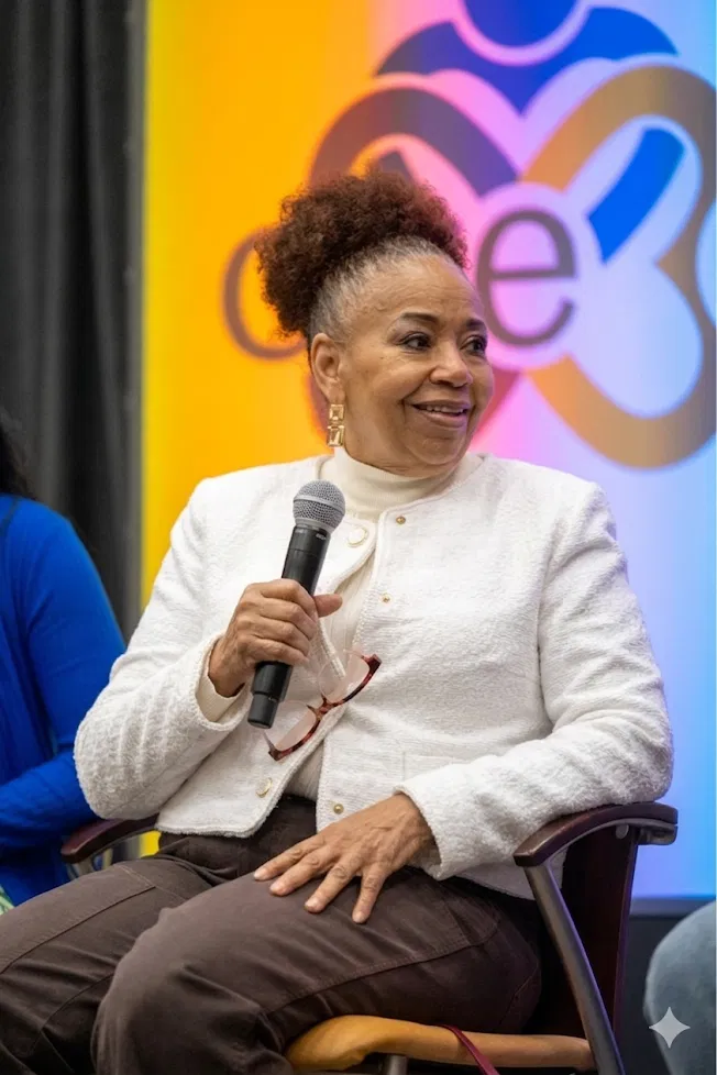 D.L. Augustine seated with a microphone during a panel discussion